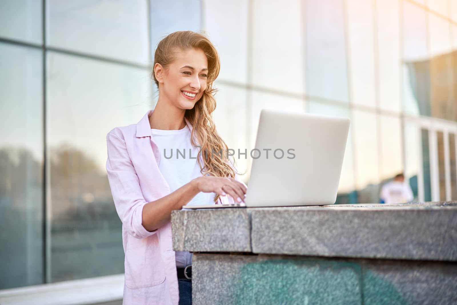 Businesswoman standing corporate building summer day using laptop Business person working remote Successful european caucasian woman freelancer make video call teacher study work online lessons