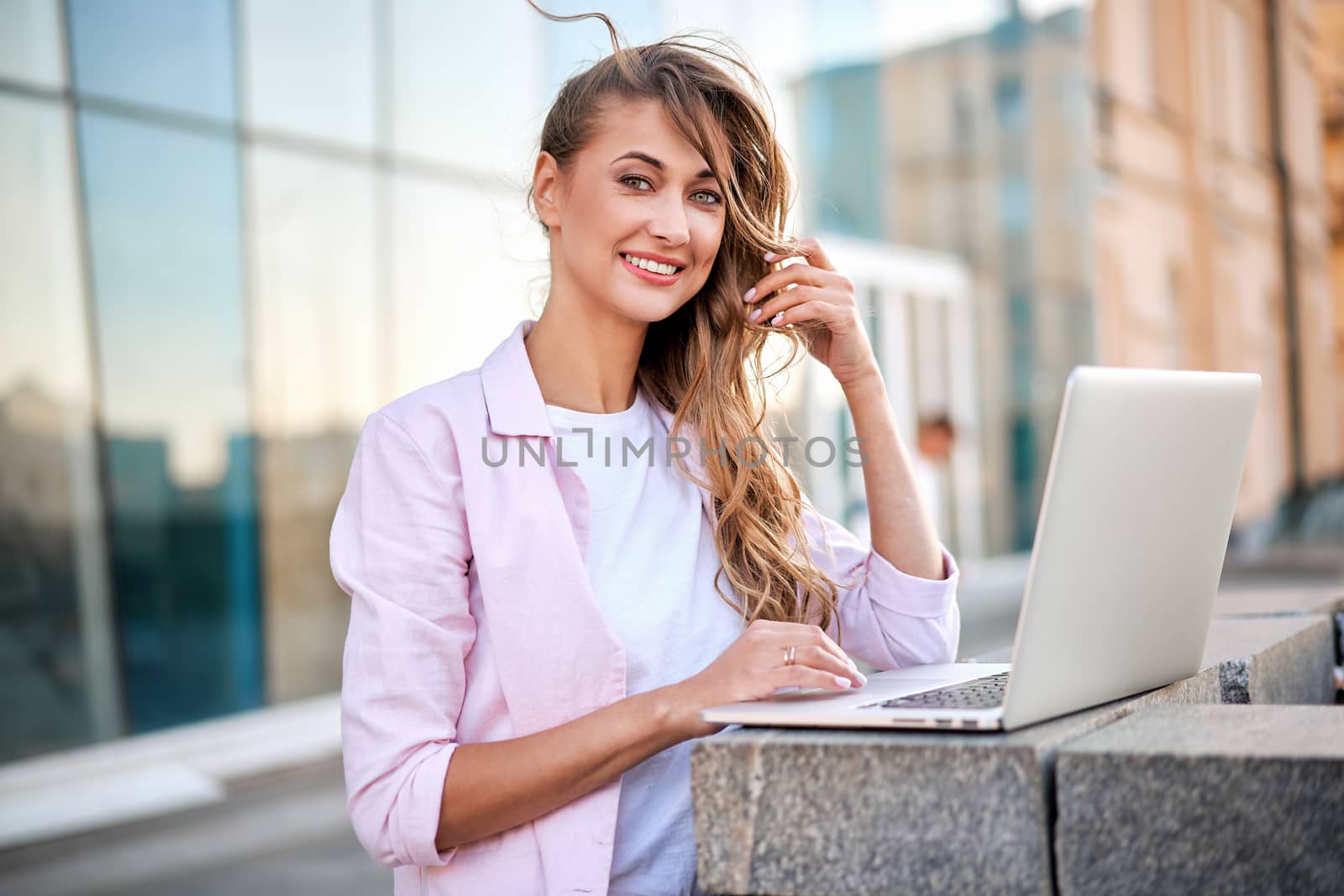 Businesswoman standing corporate building summer day using laptop Business person working remote Successful european caucasian woman freelancer make video call teacher study work online lessons