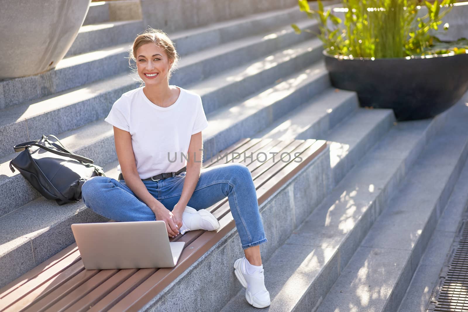 Businesswoman sitting stairs summer park using laptop Business person working remote. Outdoor Successful european caucasian woman freelancer make video call teacher study work online lessons