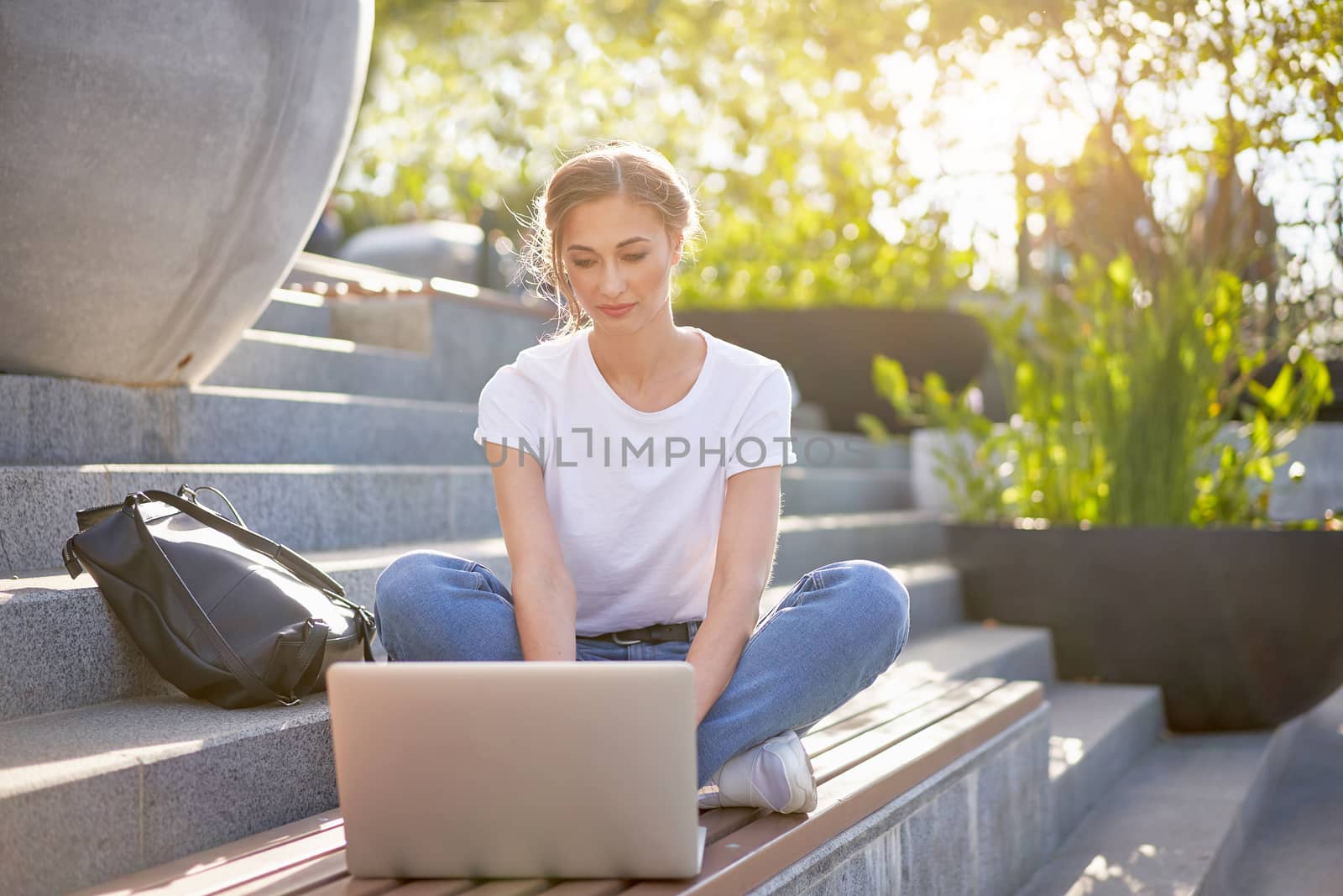 Businesswoman sitting stairs summer park using laptop Business persone working remote. Outdoor. Successful Young european caucasian woman freelancer meeting online