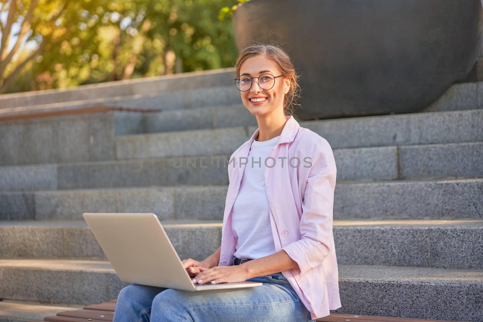 Businesswoman sitting stairs summer park using laptop Business persone working remote. Outdoor Successful european caucasian woman freelancer make video call teacher study work online lessons