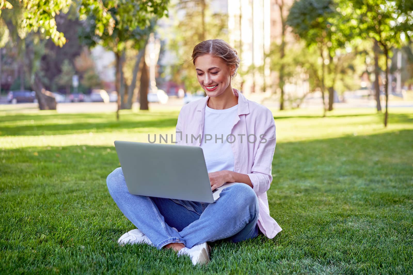 Businesswoman sitting grass summer park using laptop Business persone working remote. Outdoors Successful european caucasian woman freelancer make video call teacher study work online lessons