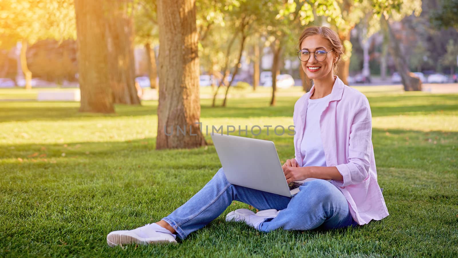 Businesswoman sitting grass summer park using laptop Business person working remote. Outdoor Successful european caucasian woman freelancer make video call teacher study work online lessons