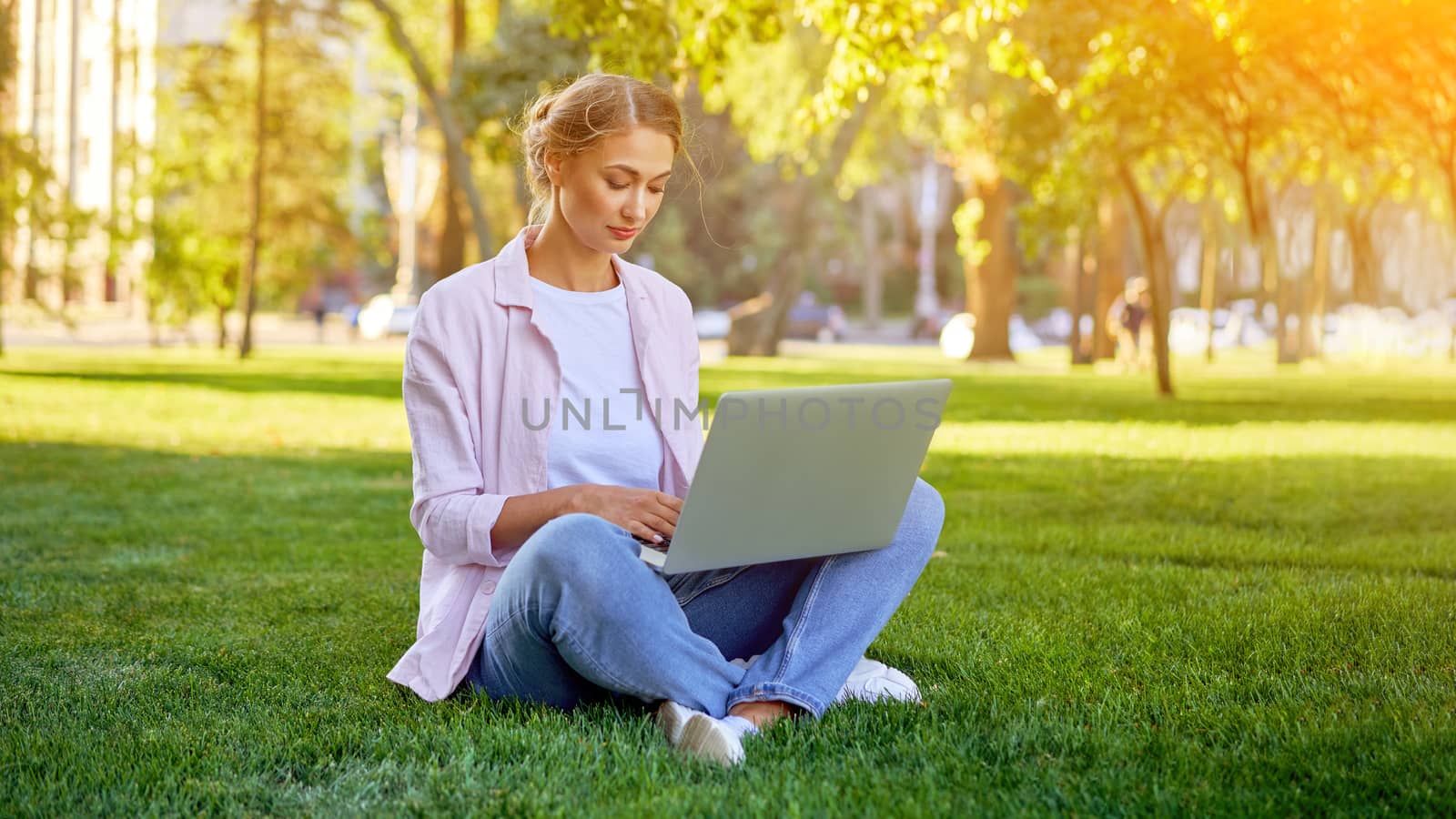 Businesswoman sitting grass summer park using laptop Business persone working remote. Outdoors Successful european caucasian woman freelancer make video call teacher study work online lessons