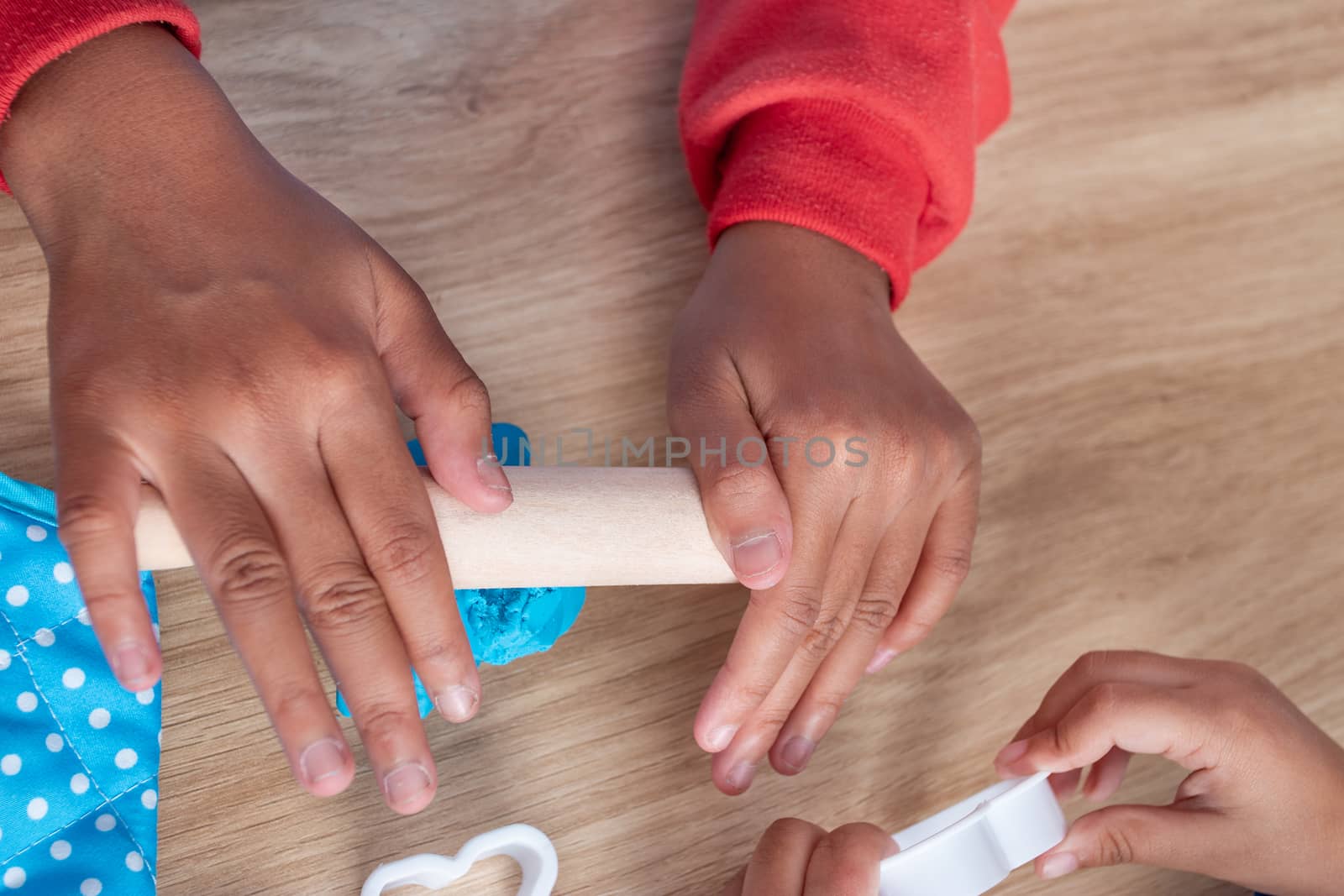 Children's hands and simulation cooking toys in the kitchen counter