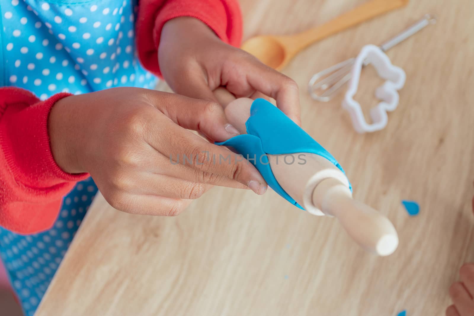 Children's hands and simulation cooking toys in the kitchen counter