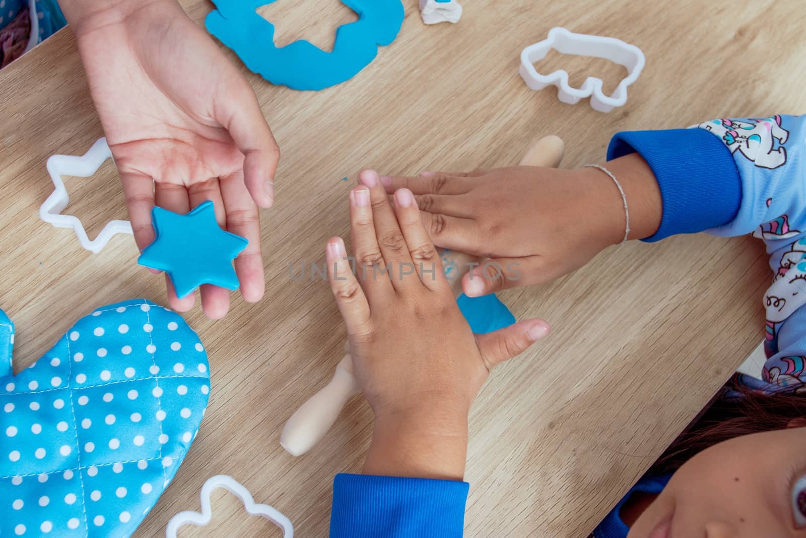 Children's hands and simulation cooking toys in the kitchen counter