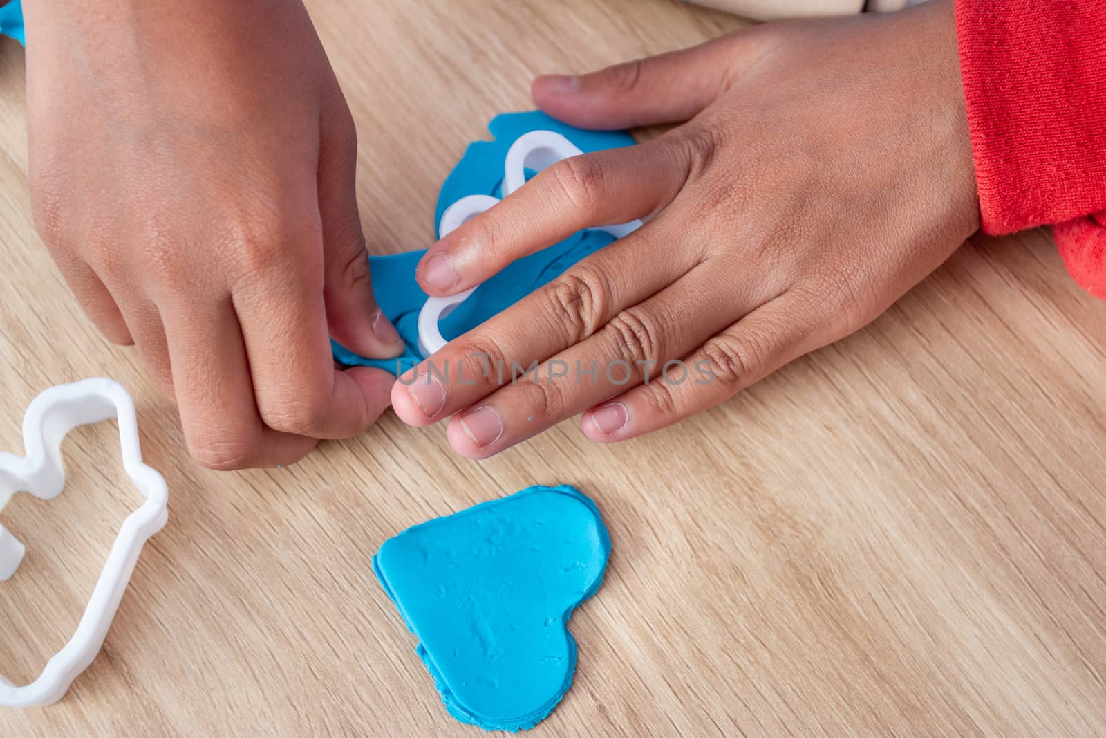 Children's hands and simulation cooking toys in the kitchen counter