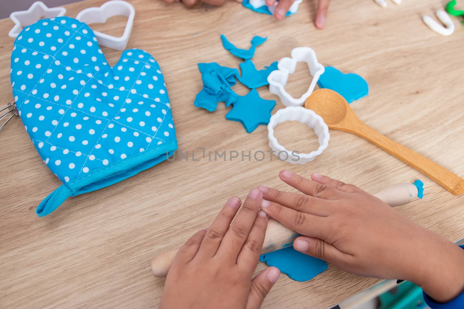 Children's hands and simulation cooking toys in the kitchen counter