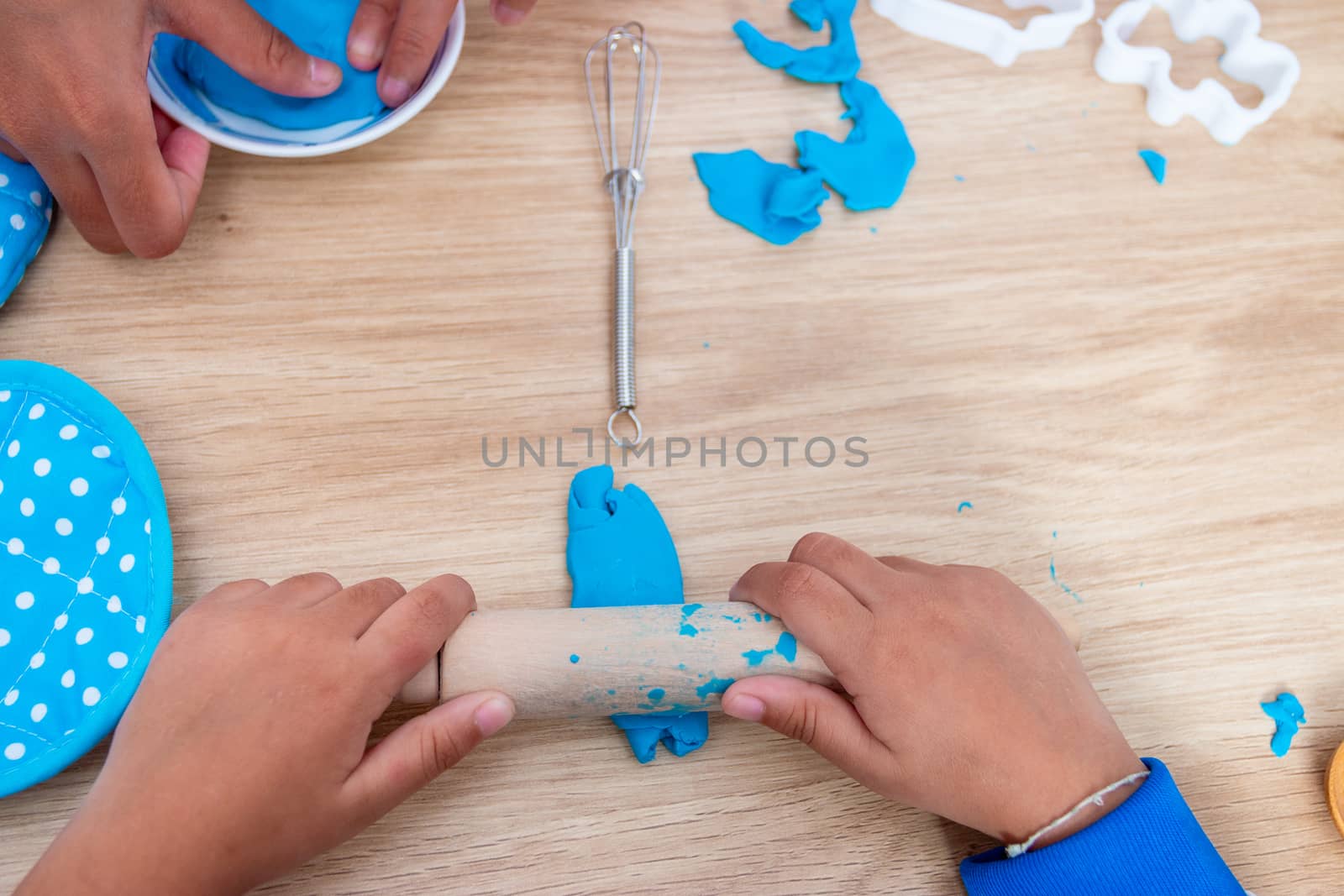 Children's hands and simulation cooking toys in the kitchen counter