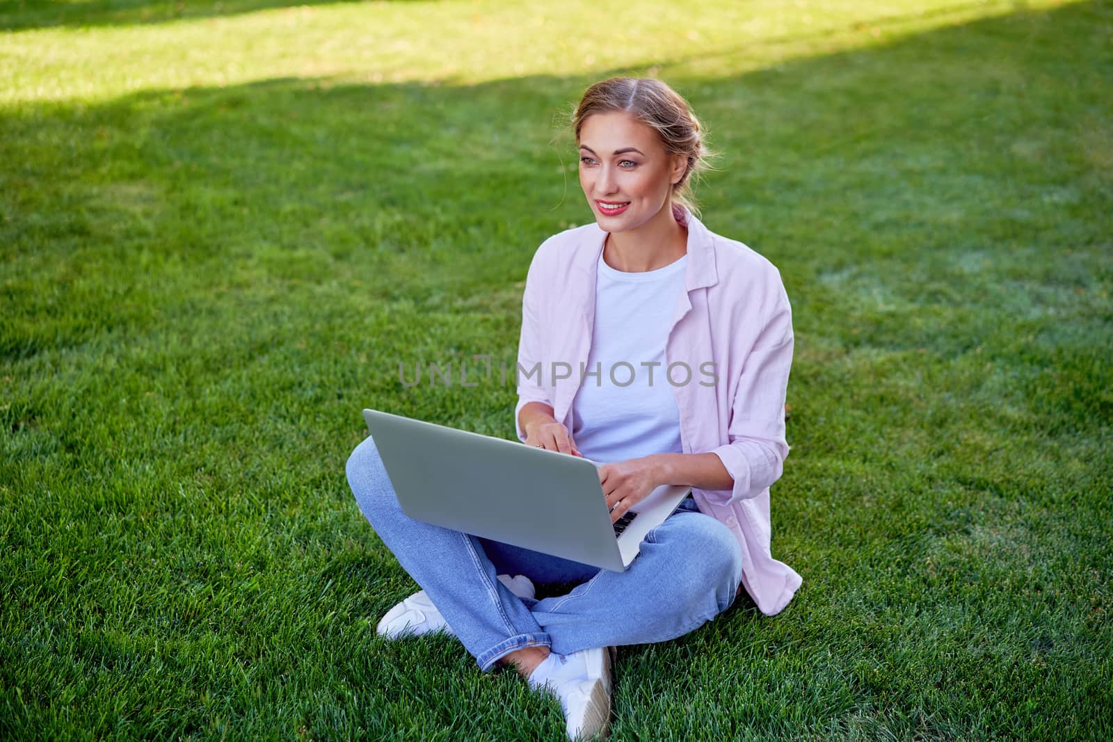 Businesswoman sitting grass summer park using laptop Business persone working remote. Outdoors Successful european caucasian woman freelancer make video call teacher study work online lessons