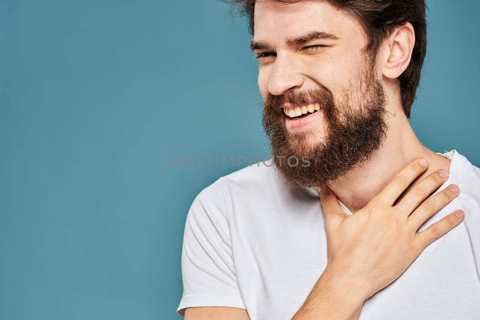 emotional man gesturing with hands lifestyle fun white t-shirt blue isolated stock. High quality photo