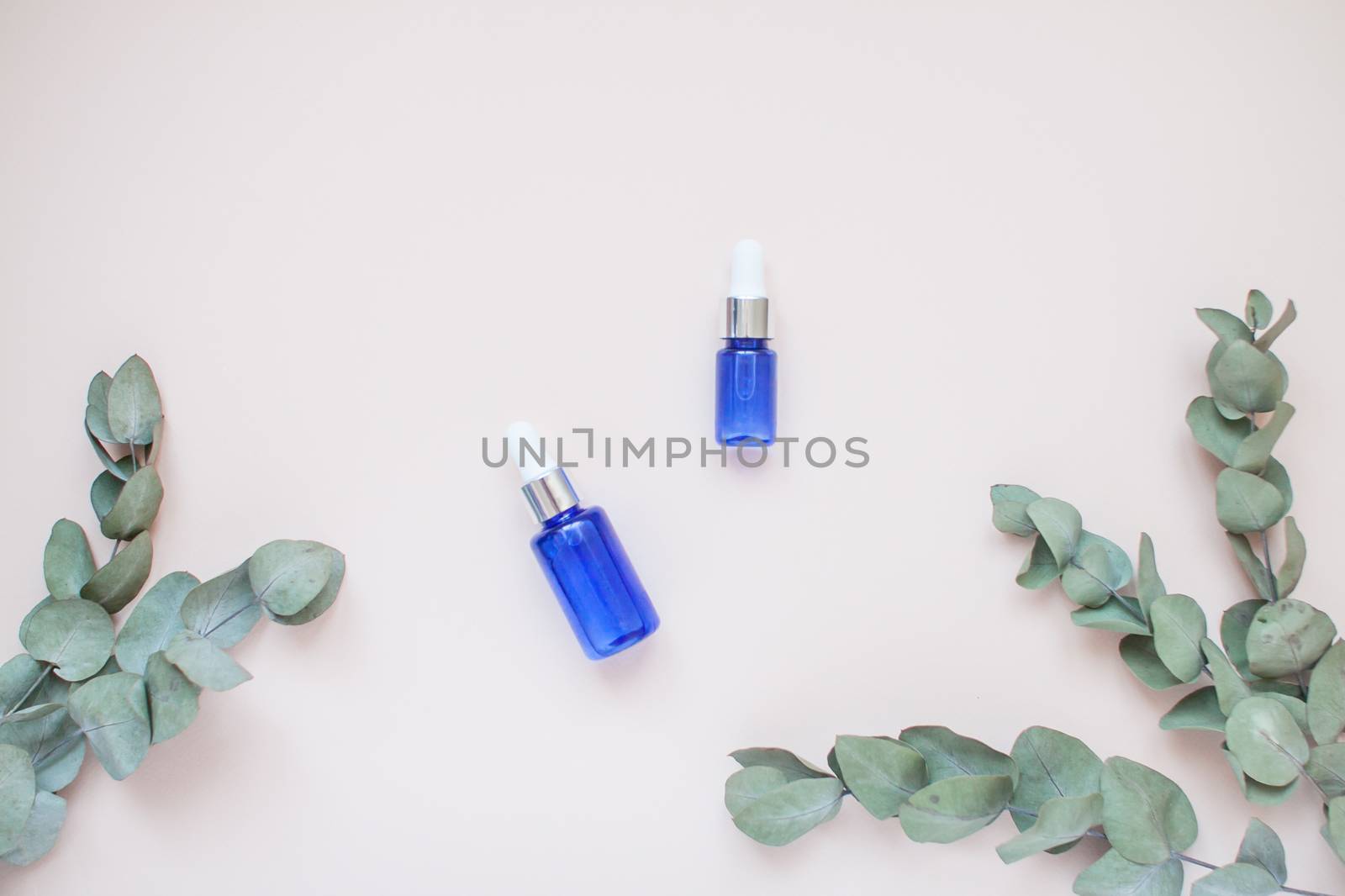 Bottles with face serum on a light background. Beauty industry. Layout