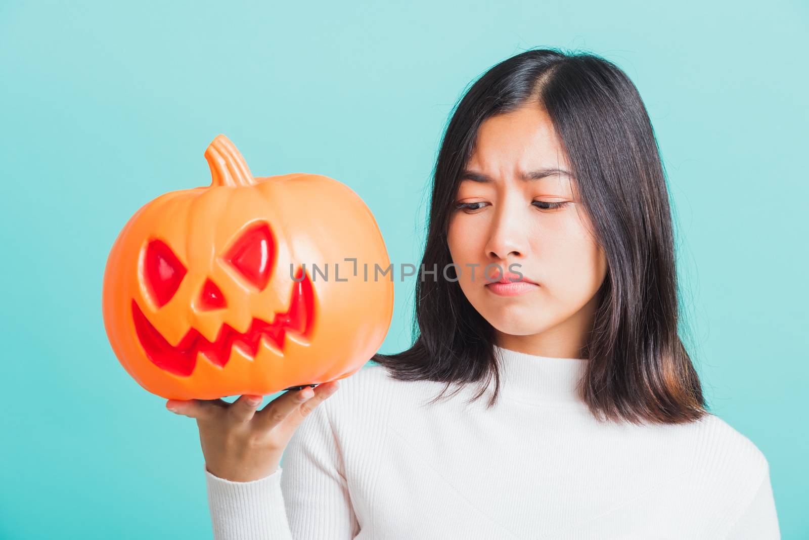 woman holding orange model pumpkins by Sorapop