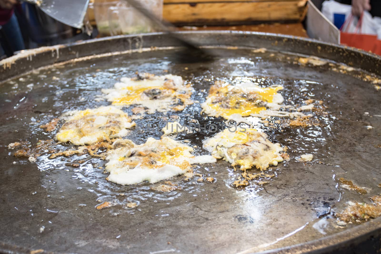 Chef cooking food fry Pan-fried crispy mussel at Street food at Yoawaraj Road Bangkok Thailand 