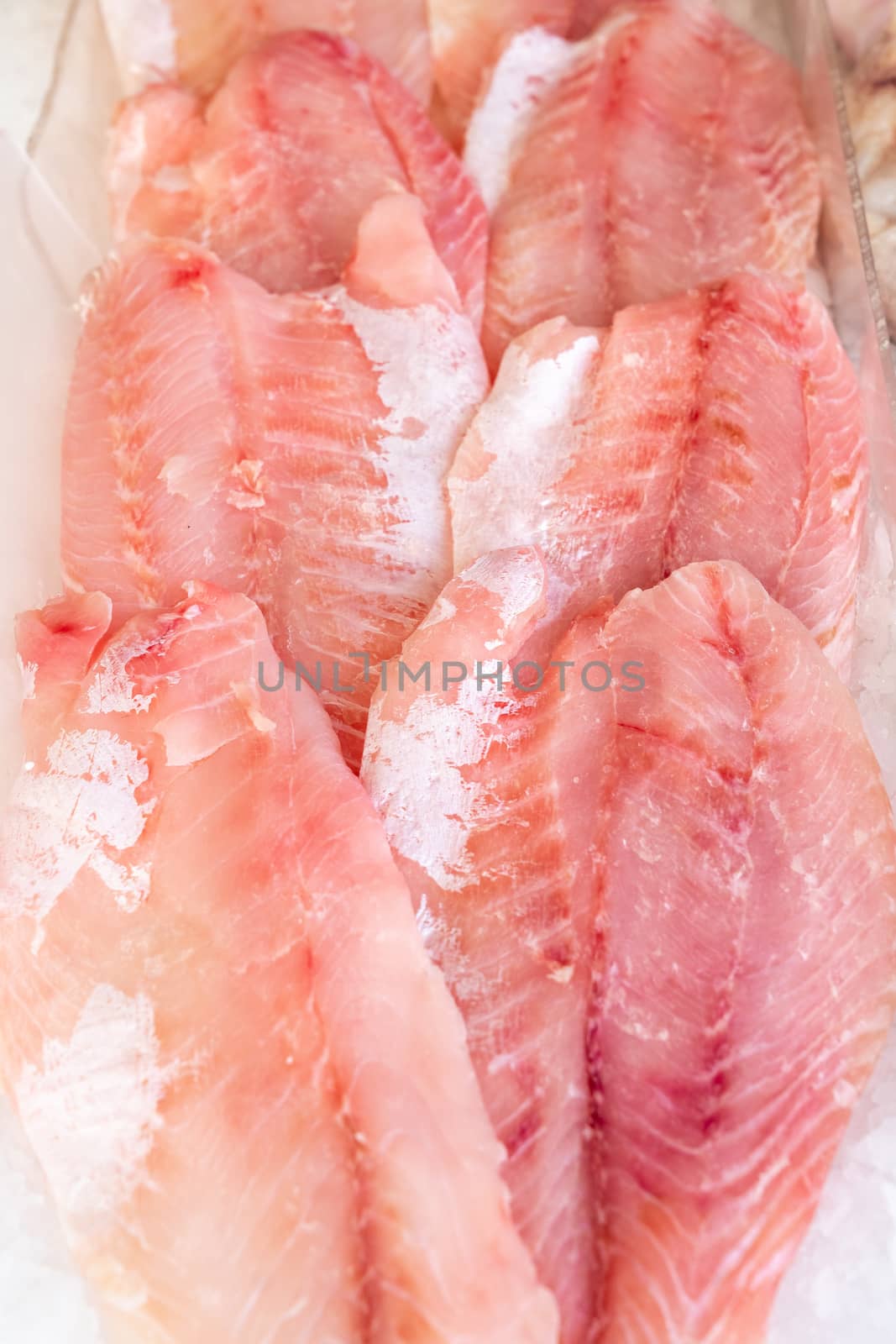 African perch fillet on ice at seafood market by Robertobinetti70