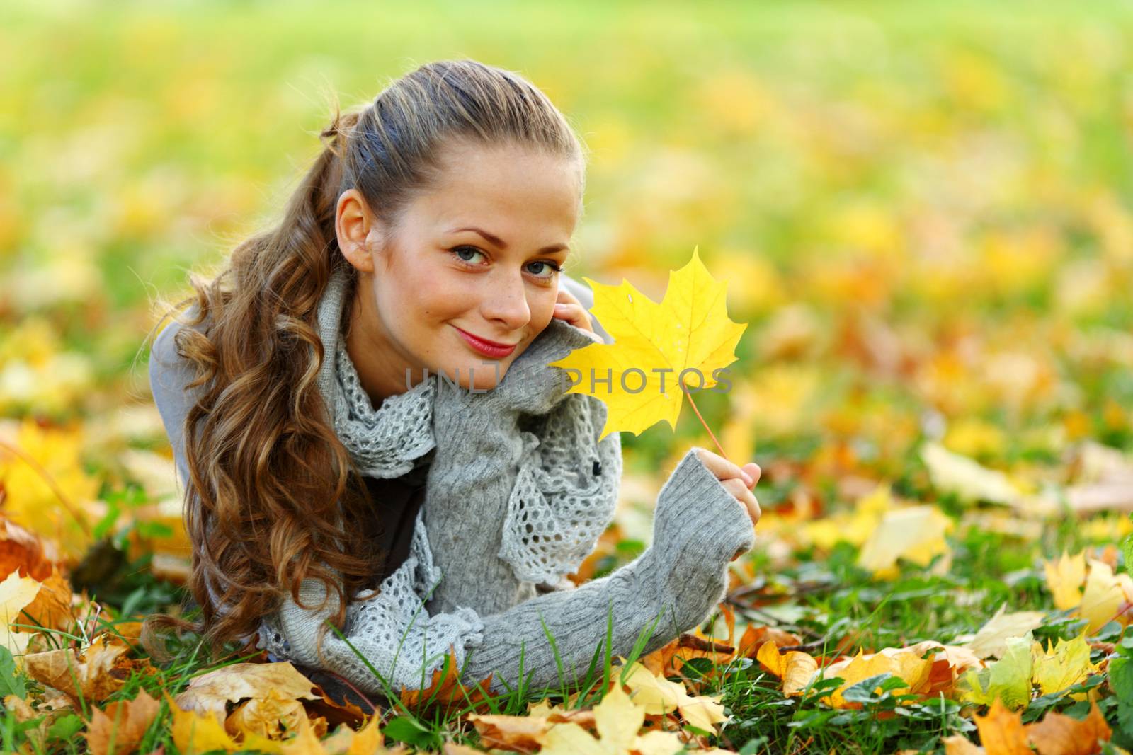 woman portrait in autumn leaf close up