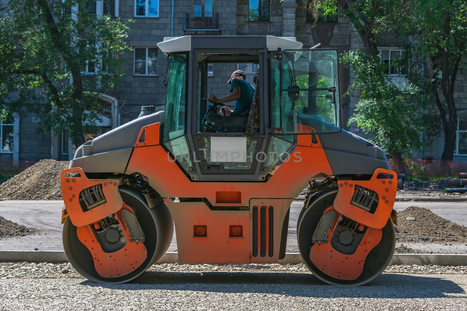 Asphalt paver in the process of building a highway and laying a new road