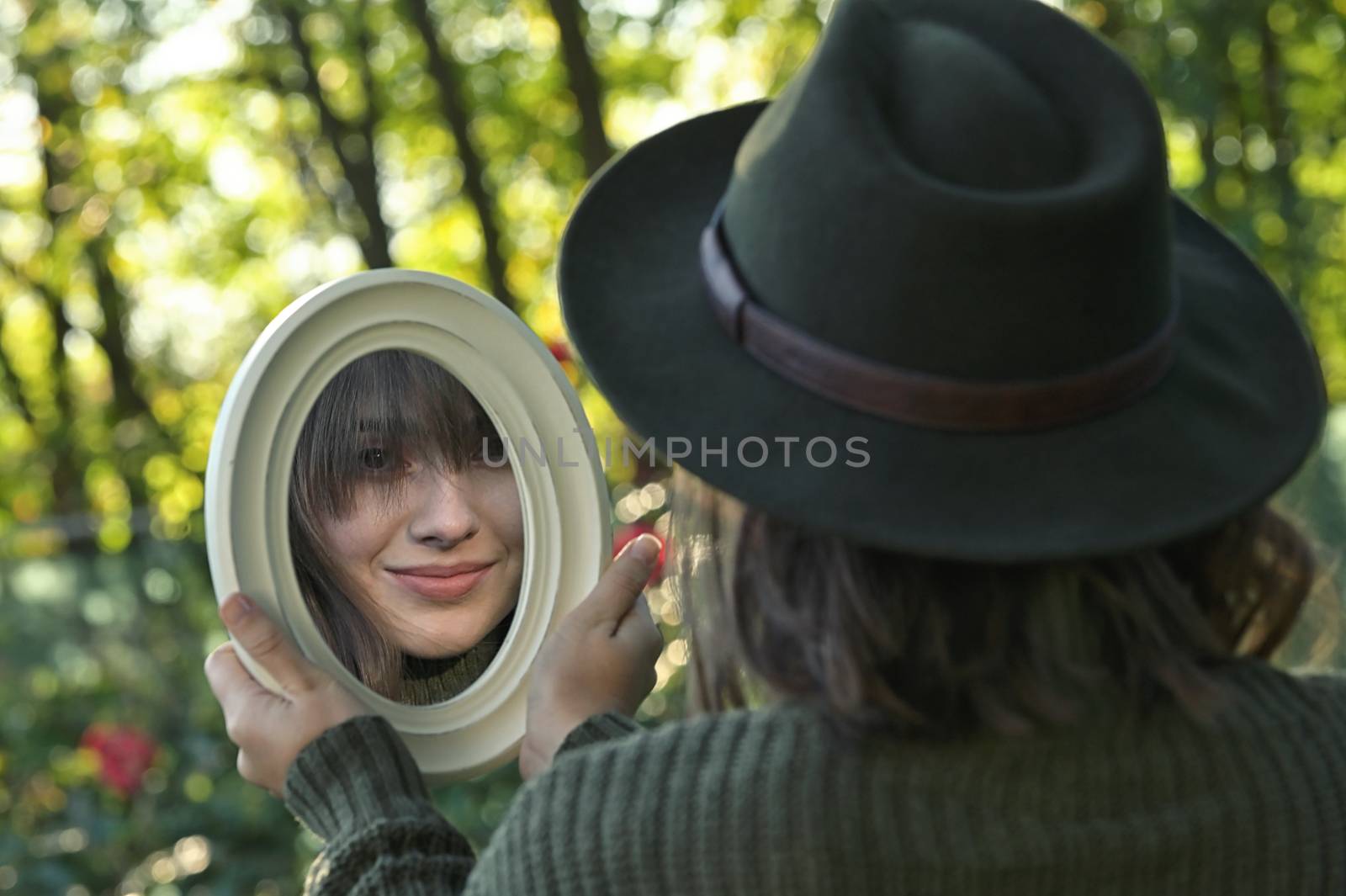Portrait Young Woman Looking in the Mirror In Forest