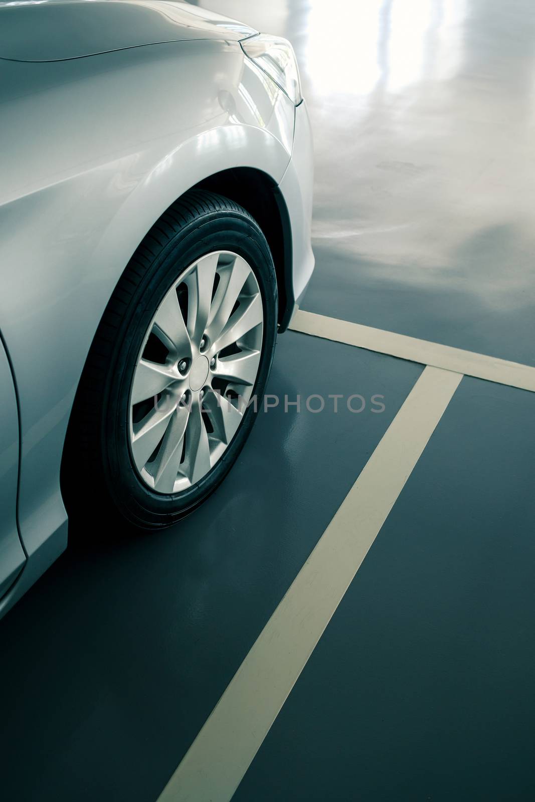 close up of modern car in parking lot, anti slip coating floor for safety, car parked in the right position in modern building carpark area