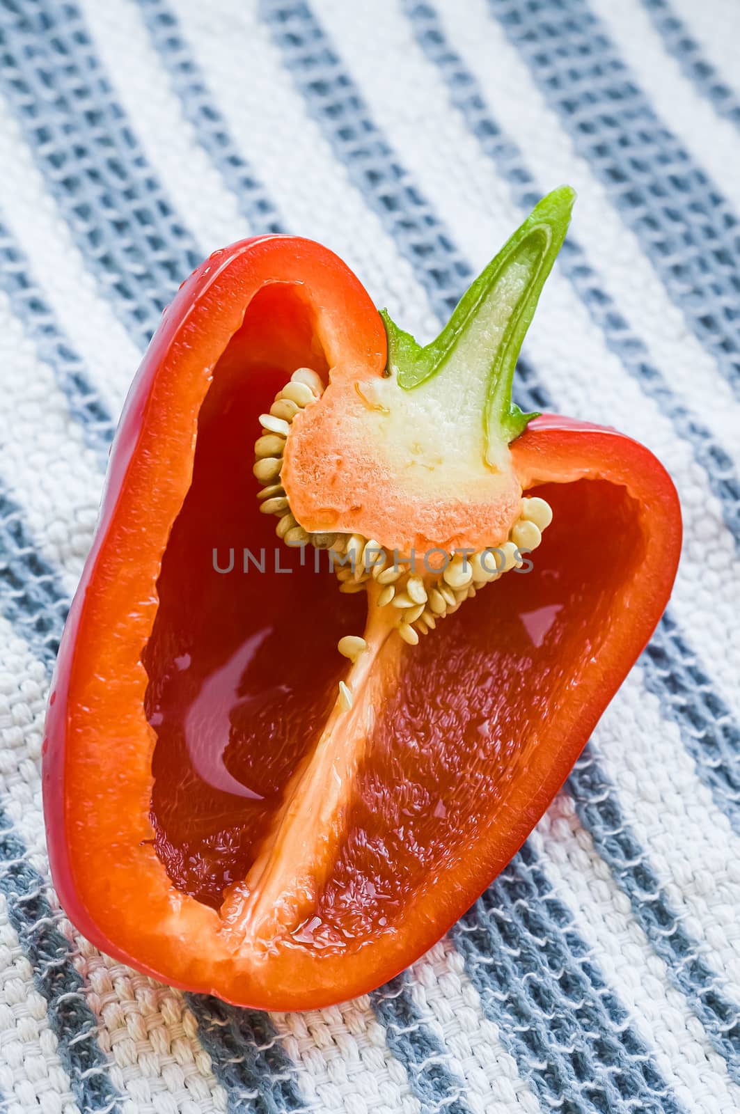 A sweet red bell pepper cut in two parts and showing the seeds and the internal