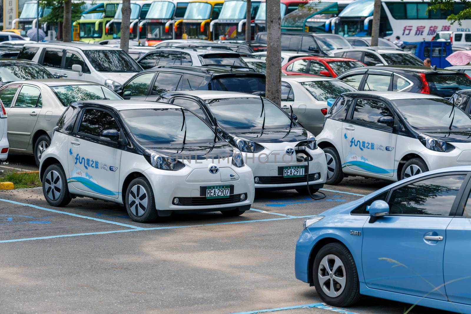 power supply connects to plug-in electric vehicle or electric car at charging kiosk in car park in Sun Moon Lake area, charging technology for future concept