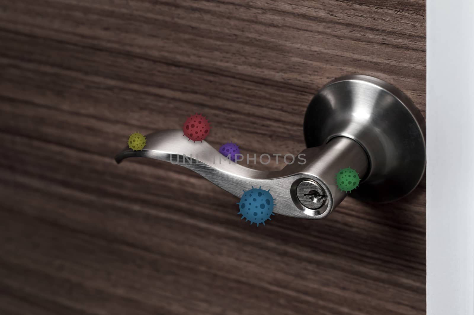 stainless door knob or handle on wooden door with virus or germ effect, concept of COVID-19 spread and prevention, shallow depth of field