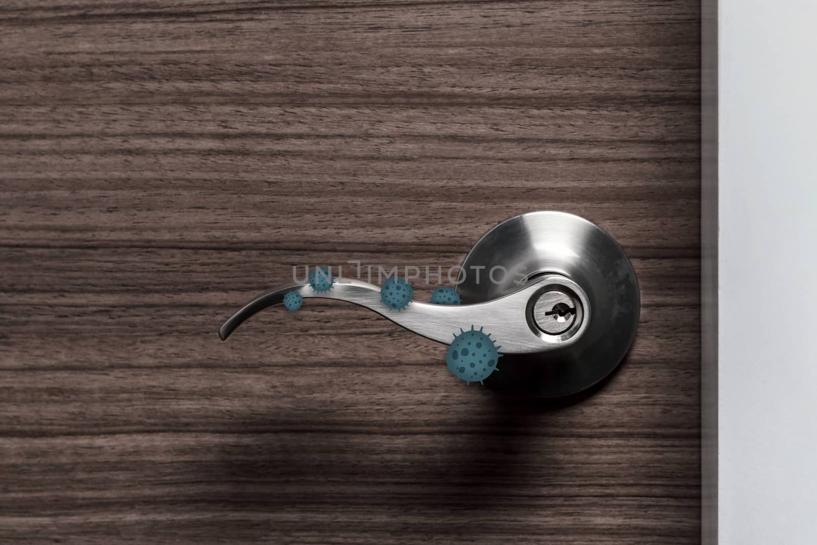 stainless door knob or handle on wooden door with virus or germ effect, concept of COVID-19 spread and prevention, shallow depth of field