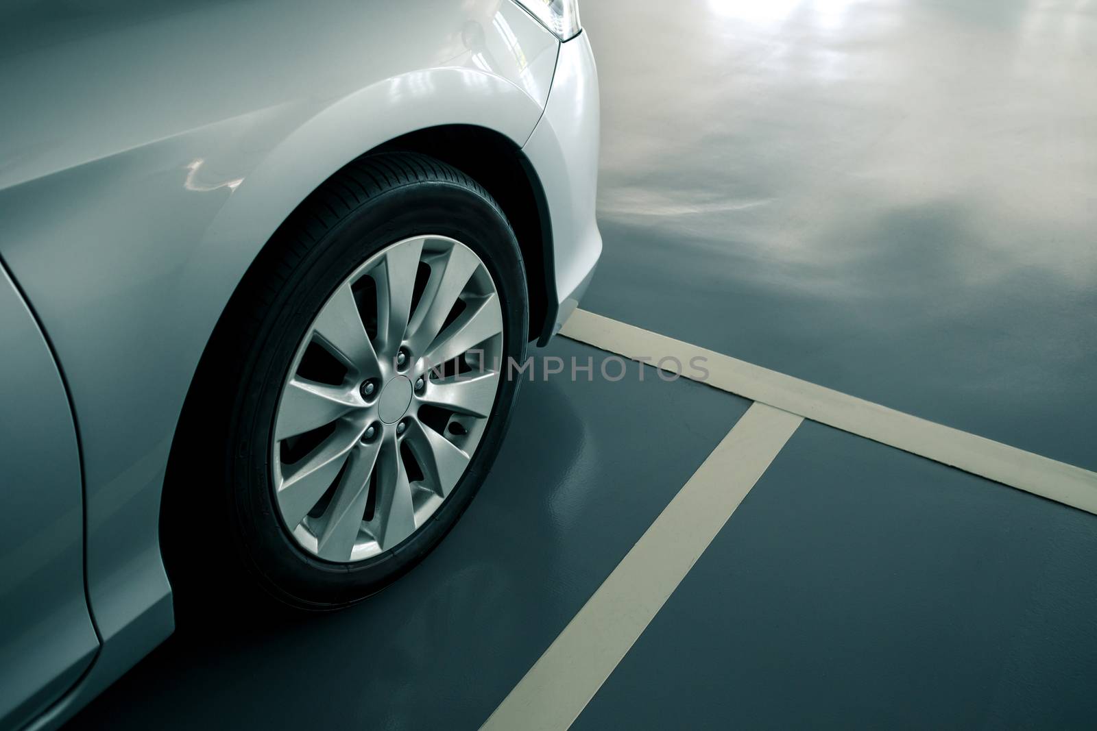 close up of modern car in parking lot, anti slip coating floor for safety, car parked in the right position in modern building carpark area