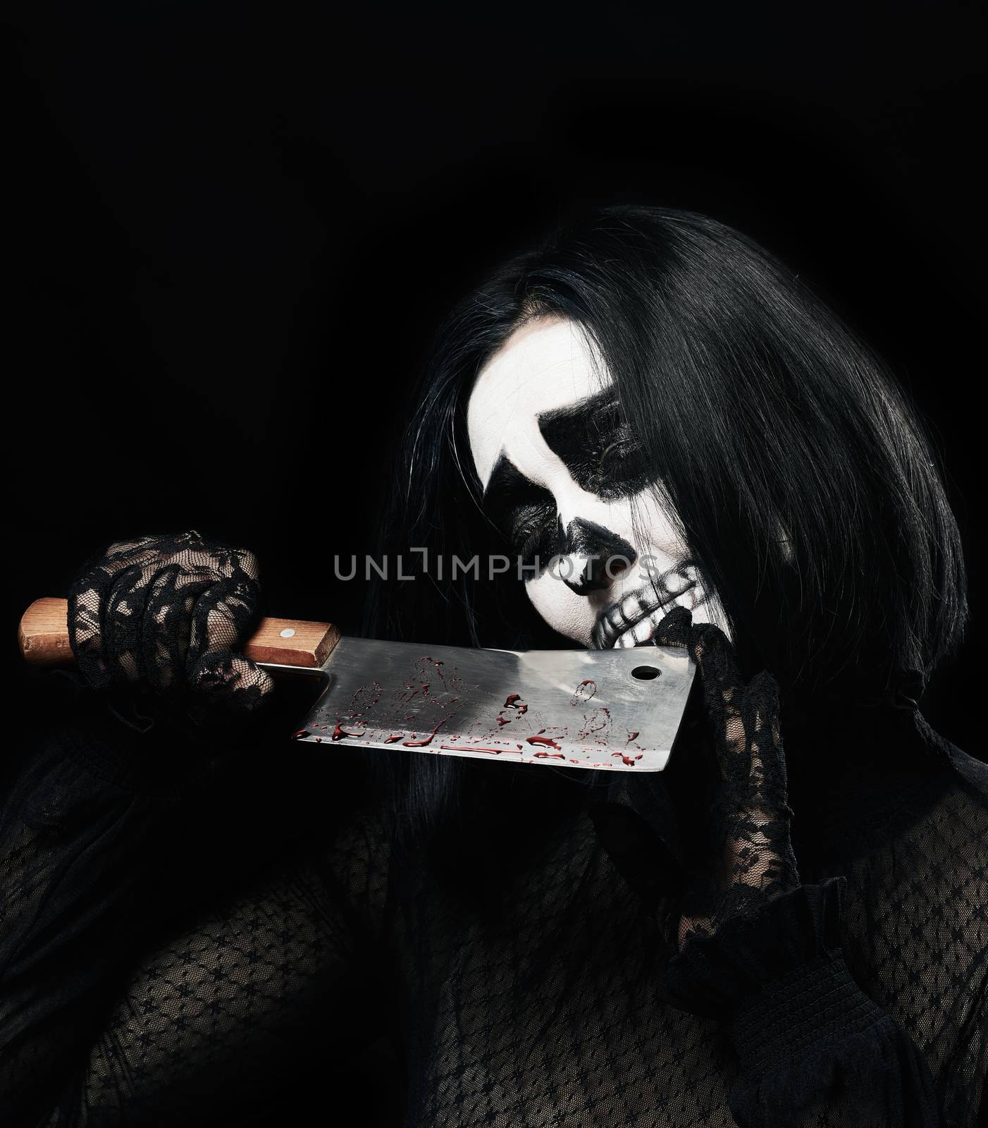 woman in black clothes and skull makeup, black background, Halloween carnival costume, holds a knife with streaks of blood in his hands