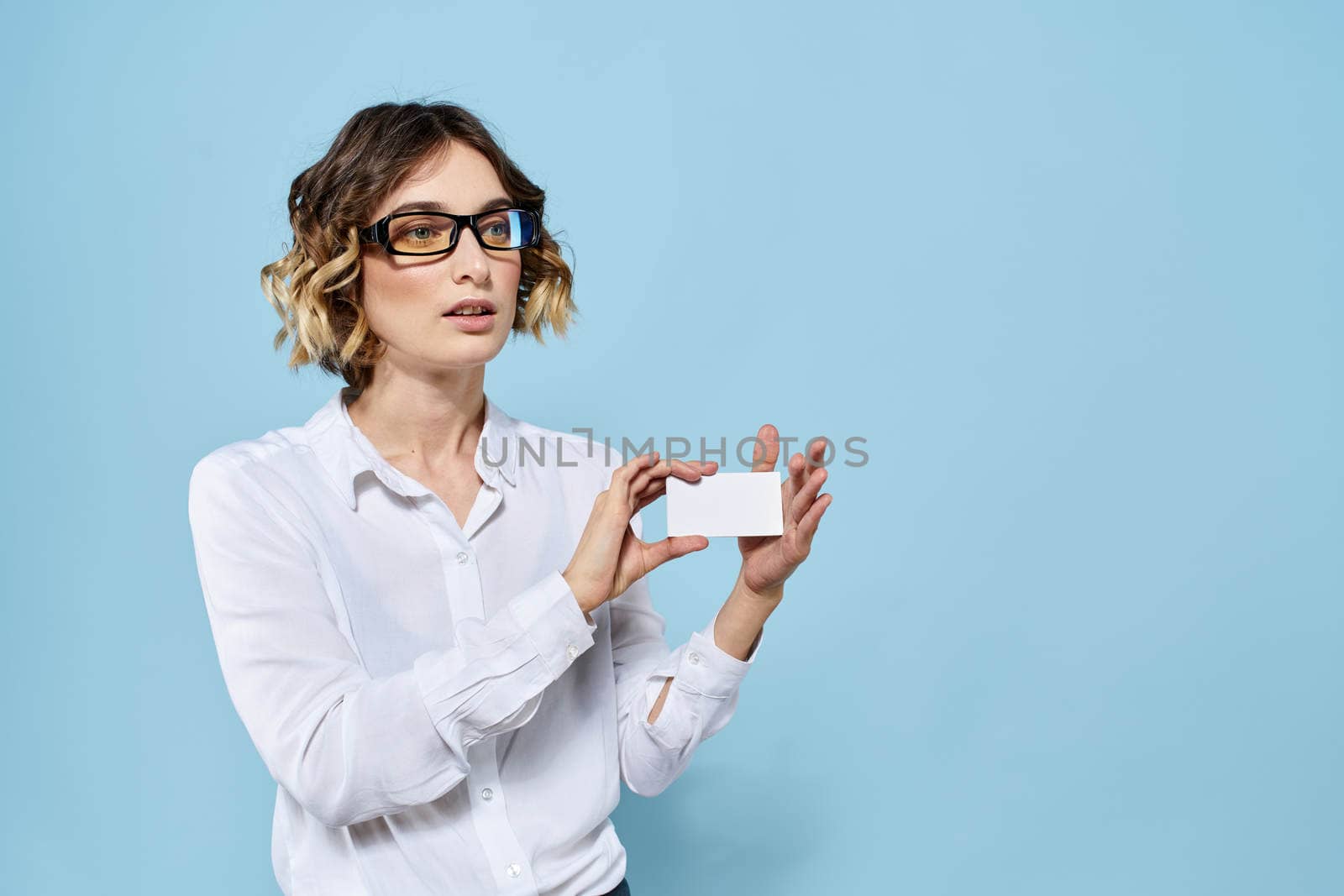 Woman wearing business card glasses in hands on blue background Copy Space cropped view. High quality photo