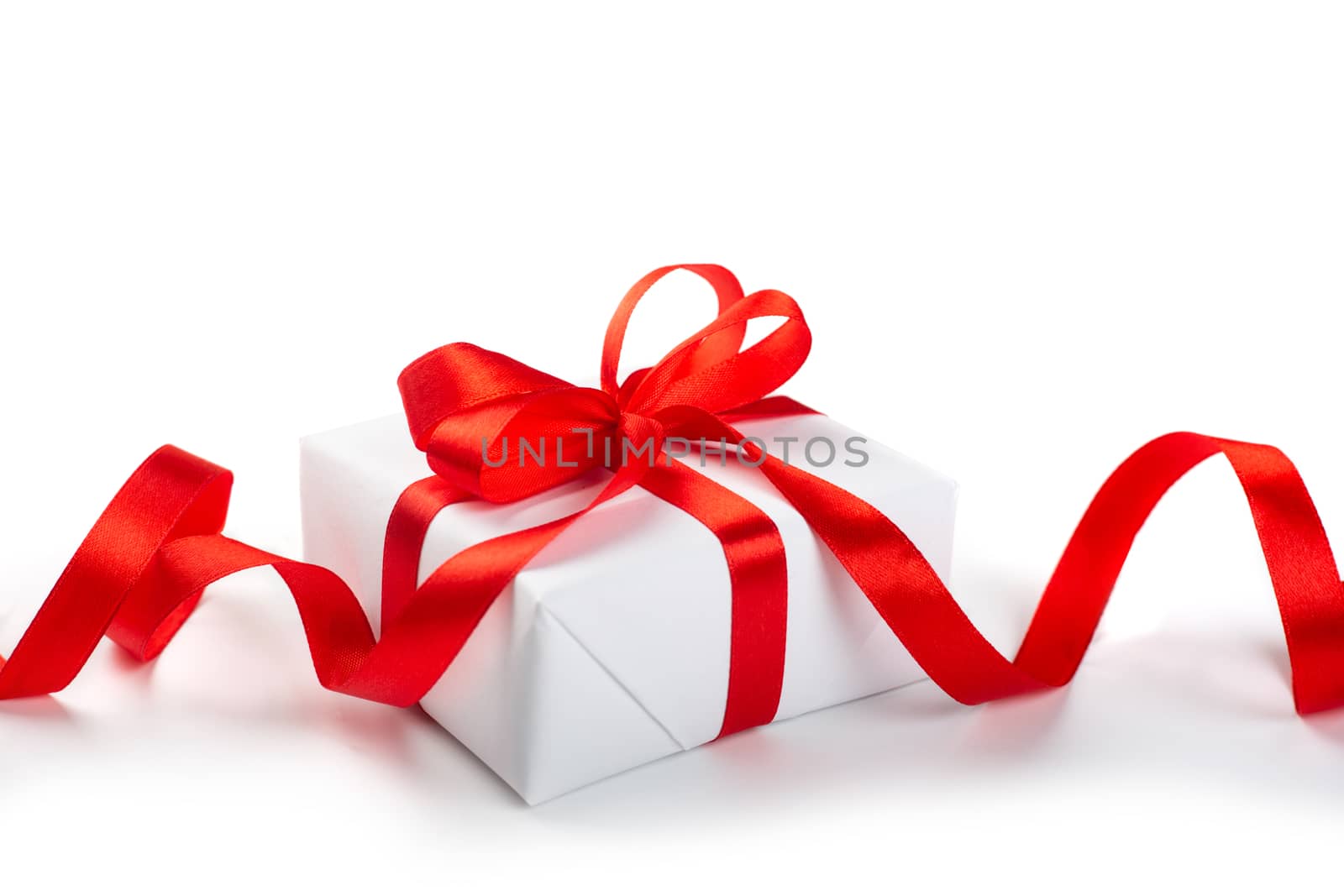 White gift box with red bow by destillat