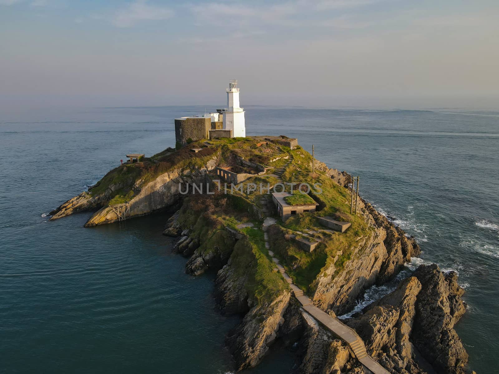 This Lighthouse Sits On An Island Off The Coast Of The Mumbles in Gower. Interesting Colours In The Sky, Blue Ocean Coastal Views.