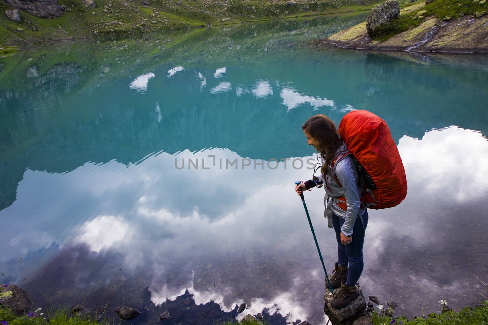 Hiker and backpacker in the mountain valley and field, trekking and hiking scene in Svaneti, Georgia by Taidundua