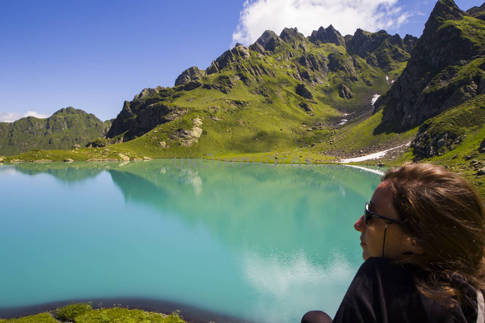 Hiker and backpacker in the mountain valley and field, trekking and hiking scene in Svaneti, Georgia, young and adult woman.