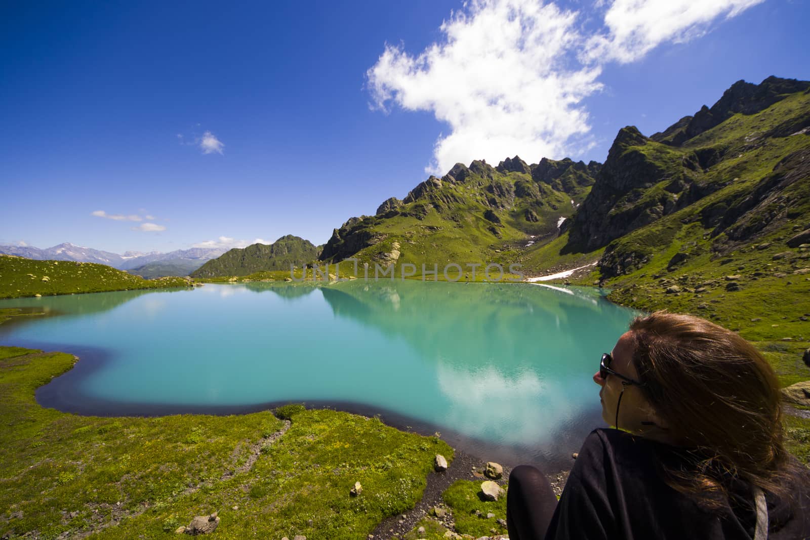 Hiker and backpacker in the mountain valley and field, trekking and hiking scene in Svaneti, Georgia by Taidundua