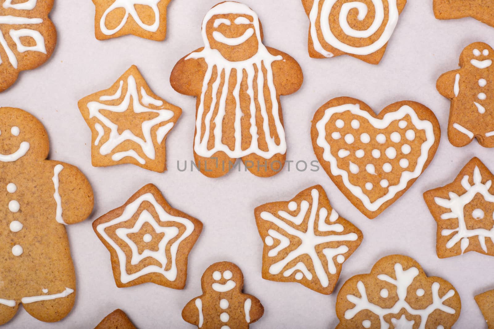 Gingerbread men stars and snowflakes glazed cookies Christmas background