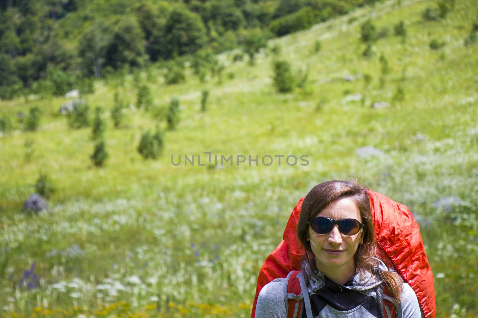 Hiker and backpacker in the mountain valley and field, trekking and hiking scene in Svaneti, Georgia by Taidundua