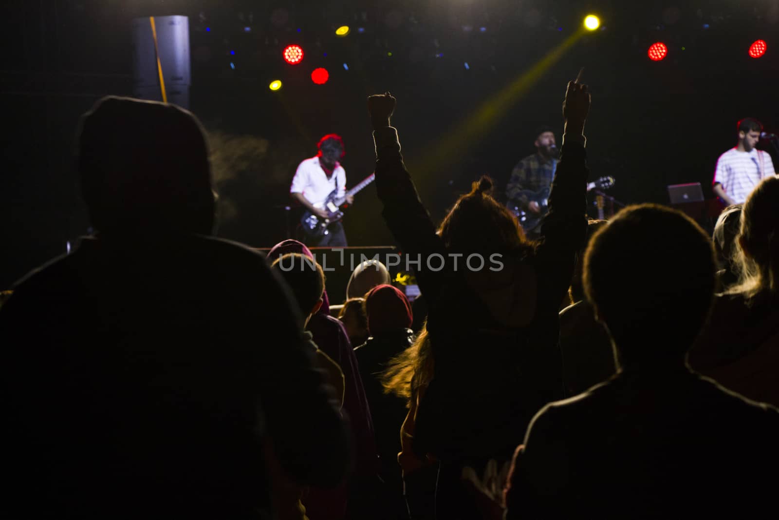 Live music concert, night life and crowd people, standing and listening music young adult people. Dark and lights.