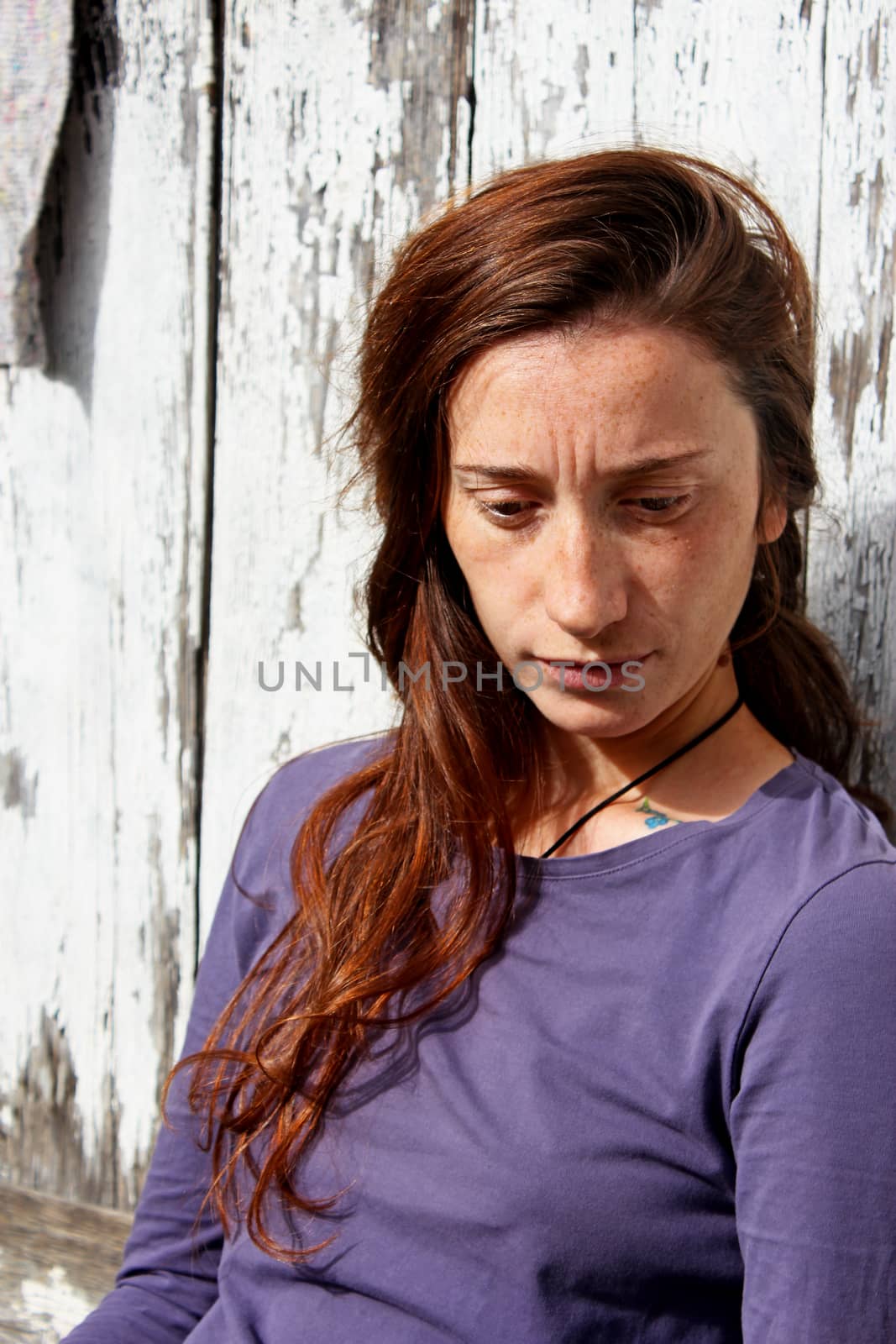 Woman portrait on the wooden background. Young beautiful ginger woman. Pretty face.