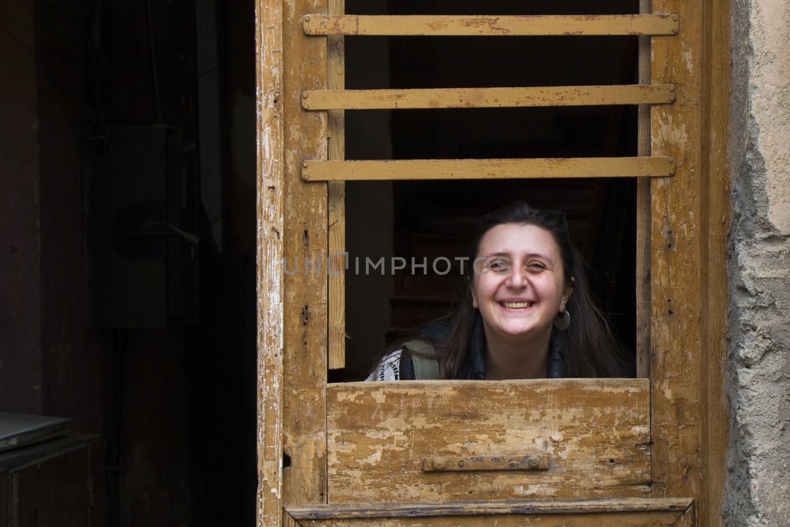 Young woman portrait, beautiful girl on the building and architecture door background. Tourist scene. by Taidundua