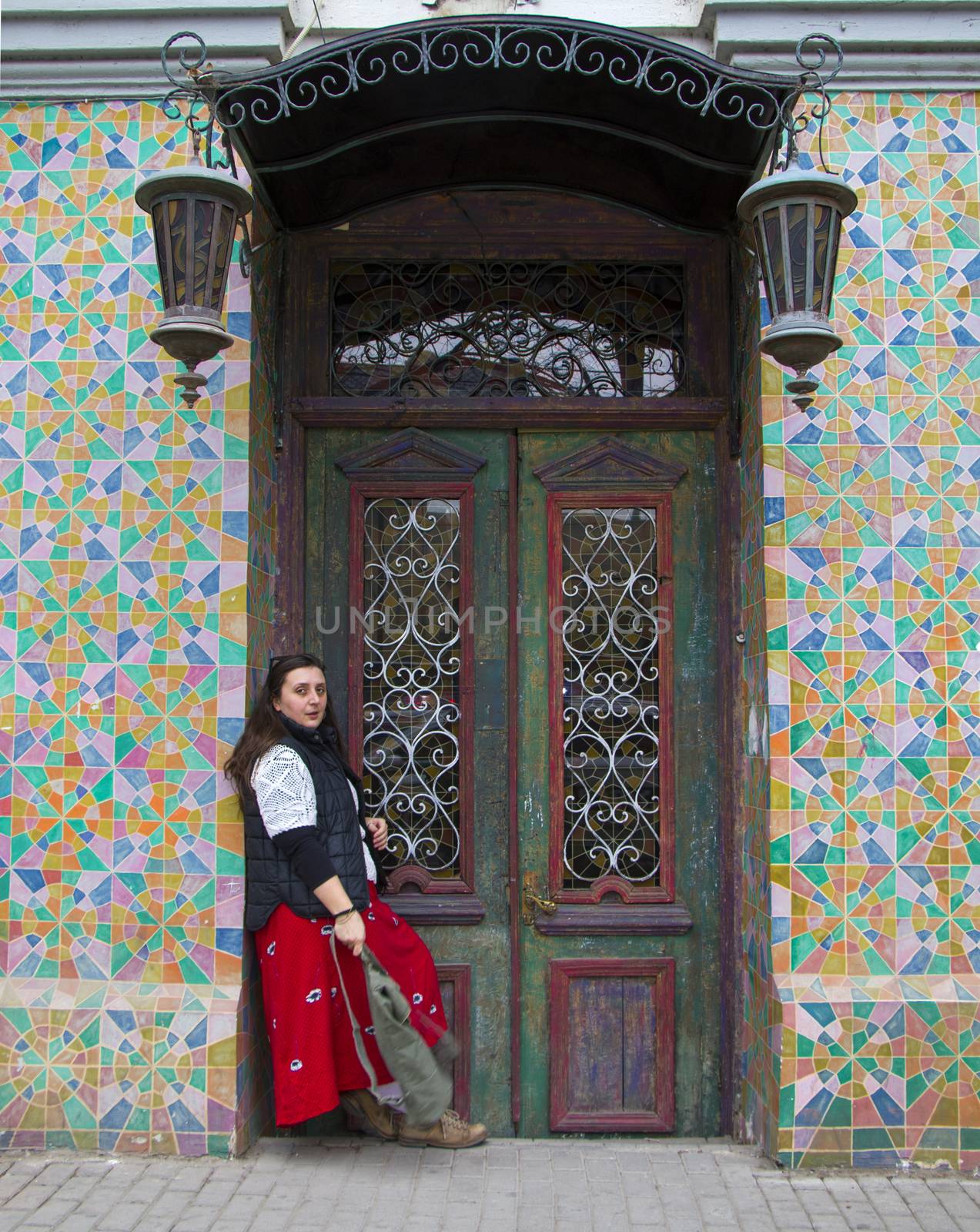 Young woman portrait, beautiful girl, pretty and cute girl on the building and architecture door background. Tourist scene.