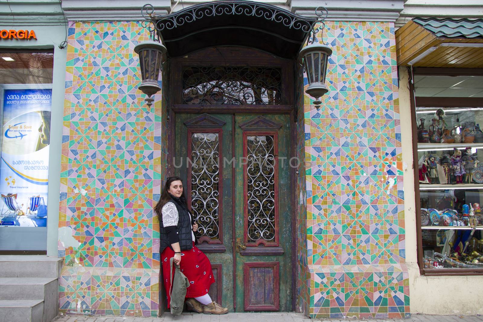 Young woman portrait, beautiful girl on the building and architecture door background. Tourist scene. by Taidundua