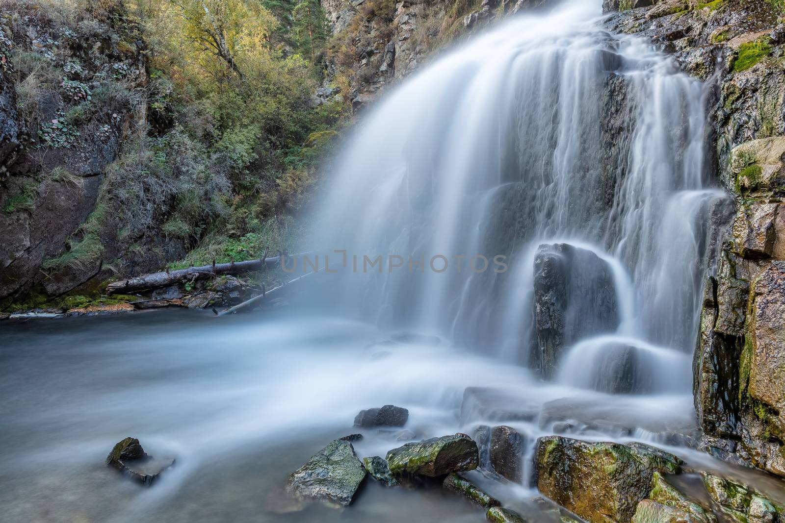 Beautiful shot of Kamischlinskiy waterfall in Altai mountains in Siberia, Russia. Smooth, silky water. Long exposure.
