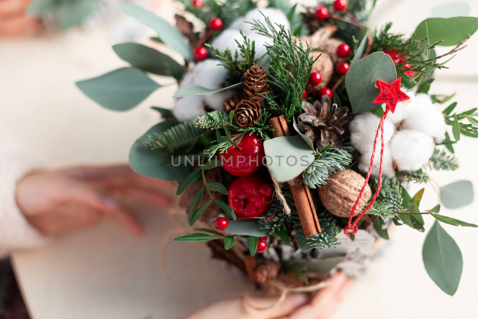 Creating Christmas floral arrangement with carnations, chrysanthemum santini flowers and fir. Floral Design basics