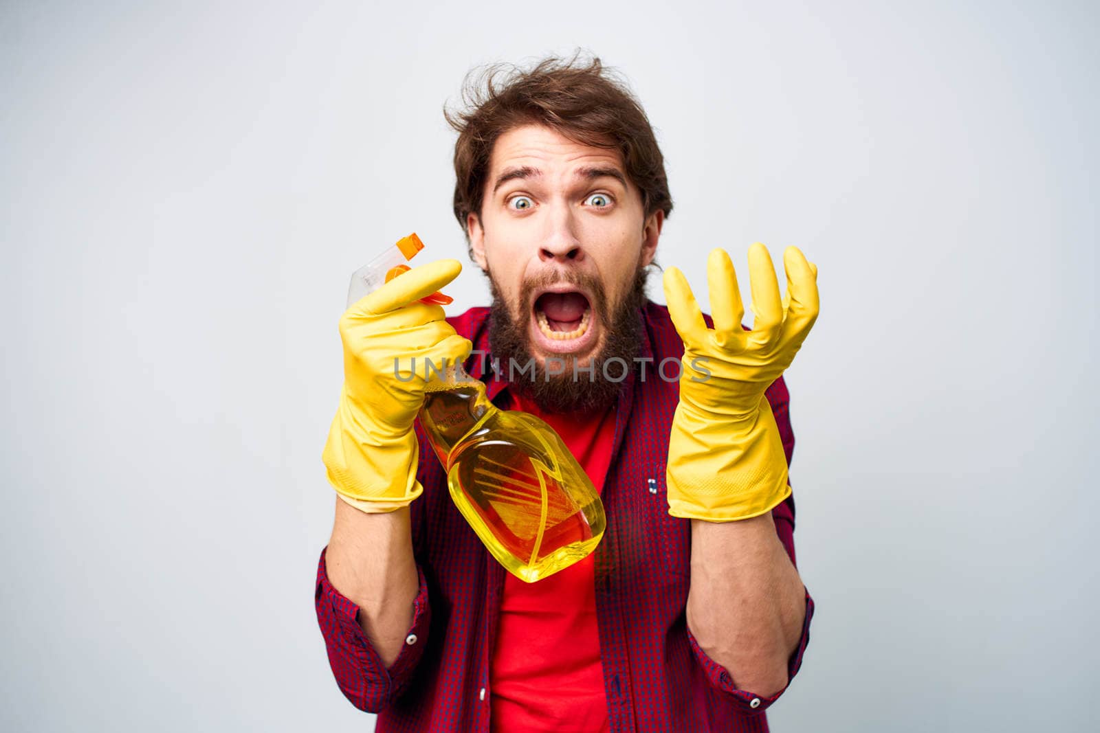 man wearing rubber gloves detergent homework lifestyle . High quality photo