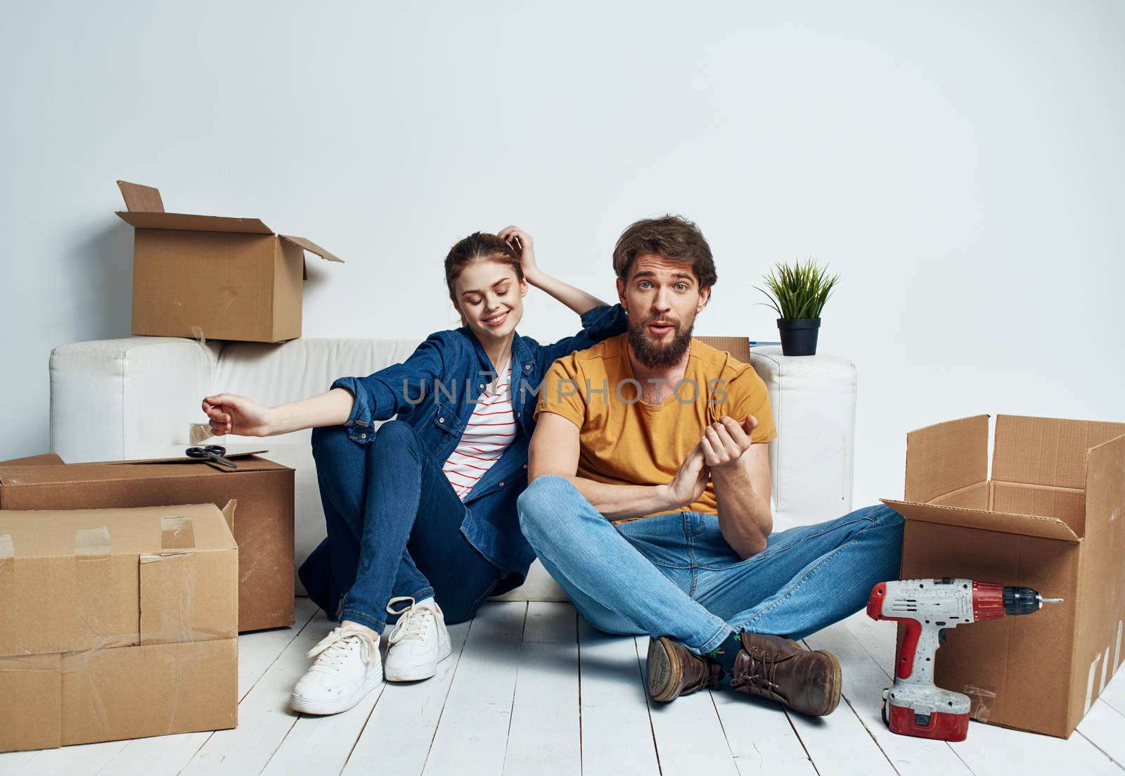Man and woman with empty boxes Moving to an apartment indoor interior. High quality photo