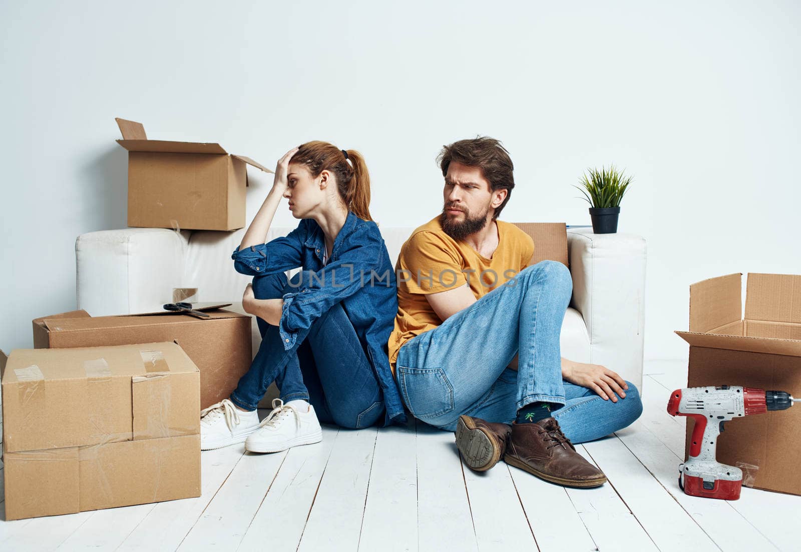 Portrait of man and woman with boxes moving plans for the future apartment. High quality photo