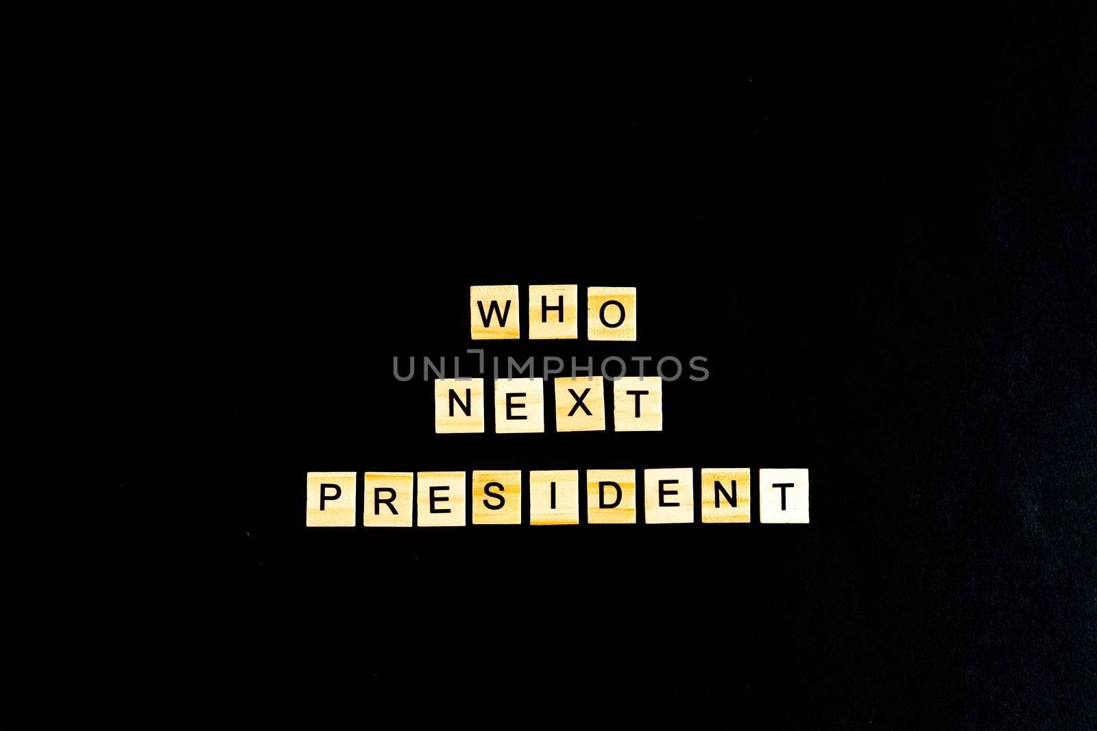 The phrase Who is the next American President - with an American flag in the background. A new election race in the United States. Primary. Candidates. Politics. Government. Force. flatlay, top view.