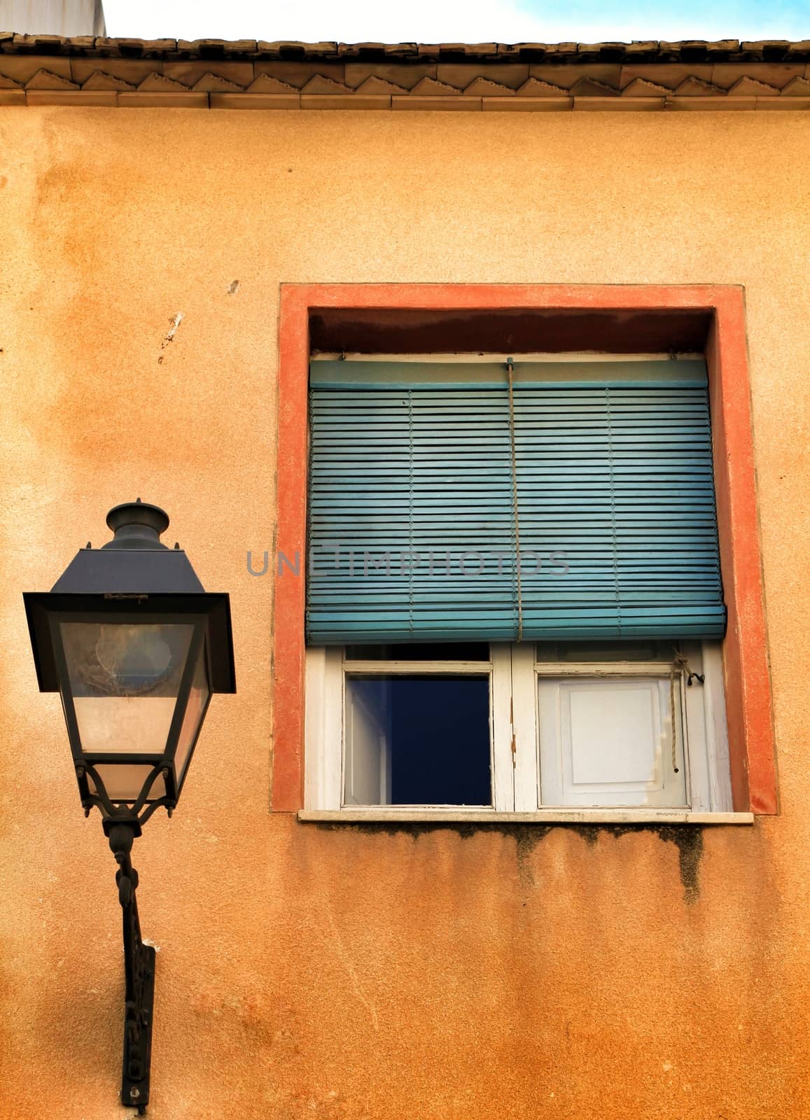 Old and damaged facade in Lisbon. Vintage Street light on the wall